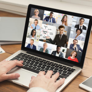 Closeup Of Laptop Screen With Group Of Diverse Business People Having Video Call Communicating six sigma Virtually. Unrecognizable Businesswoman Video Calling Coworkers Having Corporate Meeting Sitting In Office